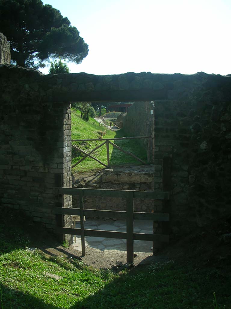 Porta di Nocera or Nuceria Gate, Pompeii. May 2010. 
Looking west towards Via di Nocera, through entrance in wall at north end of gate on east side.
Photo courtesy of Ivo van der Graaff.
