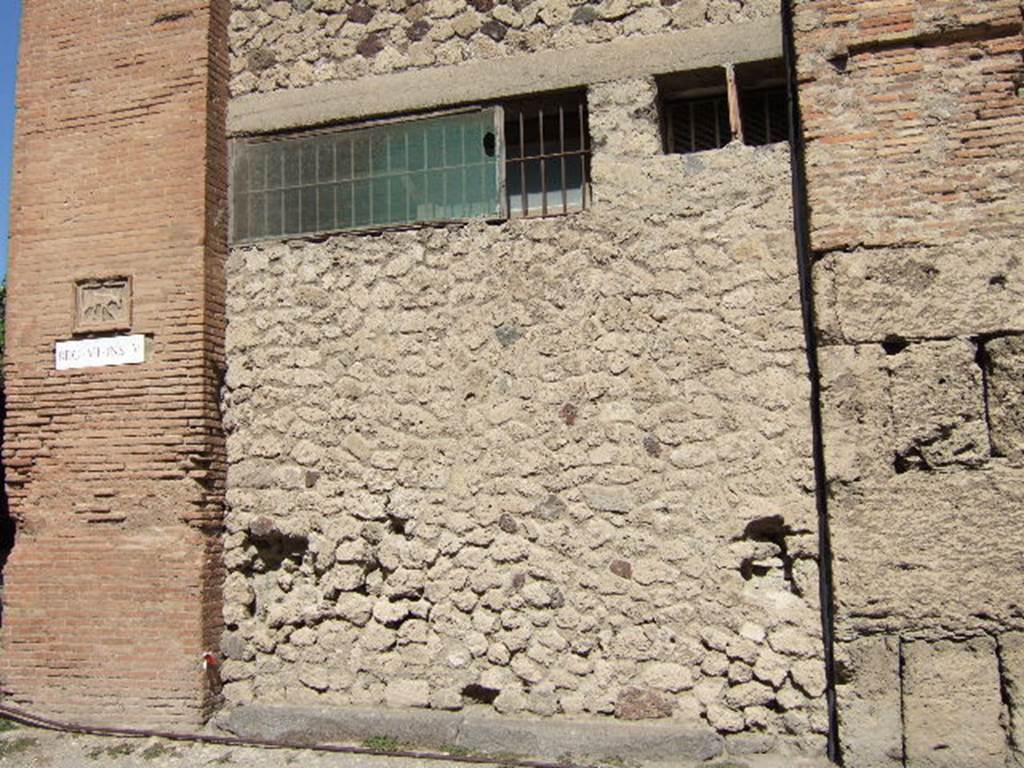 VII.5.14 Pompeii. September 2005. Looking north towards original entrance on south side of insula.  According to Garcia y Garcia, all of the south-west corner and southern part of the insula were transformed in the time of Maiuri. Then the area was hit during the first bombing incursion during the early evening (17.00hrs) of 13th September 1943. All of the old structures have been modified again to provide a restaurant, latrine and sales area. The modifications included closing and bricking up of the old doorways to VII.5.14, 15, 16 and 17. Entrances at VII.5.18, 19 and 20 now provide the doorways to the modern restaurant.  See Garcia y Garcia, L., 2006. Danni di guerra a Pompei. Rome: L’Erma di Bretschneider. (p.101-3) 

According to Fiorelli, the shop originally had a sales-counter clad largely in marble, and with only one urn of terracotta. At the rear were the stairs to the upper floor, a dormitory, a kitchen with hearth, near to the kitchen was a small stall. See Pappalardo, U., 2001. La Descrizione di Pompei per Giuseppe Fiorelli (1875). Napoli: Massa Editore. (p.96)

According to Boyce, in the east wall was a square niche.
See Boyce G. K., 1937. Corpus of the Lararia of Pompeii. Rome: MAAR 14. (p.66, no.284) 