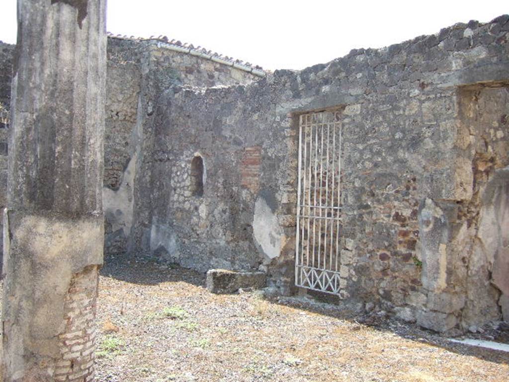 VII.15.13 Pompeii. September 2005. Looking south-west across west side of atrium, with site of stairs above niche.
