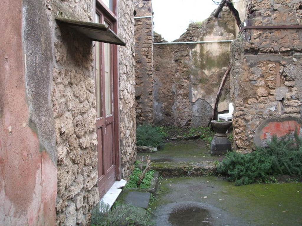 IX.1.26 Pompeii. December 2004. Looking north from entrance corridor across atrium.
On the left would have been a cubiculum and also the triclinium, where the graffito
SODOM(A)  GOMORA  [CIL IV 4976] was found.  
It was inscribed in large letters in charcoal on the wall.
See Cooley, A. and M.G.L., 2004. Pompeii : A Sourcebook. London : Routledge. (p.110)
See Varone, A., 2002. Erotica Pompeiana: Love Inscriptions on the Walls of Pompeii, Rome: L’erma di Bretschneider. (p.141)
See Dobbins, J & Foss, P., 2008. The World of Pompeii. New York: Routledge. (p.195)
According to Mau, the inscription SODOMA
                                                                GOMORA
was found in a triclinium on the left side of the atrium, on the left wall.
See Mau in BdI, 1885, (p.97)
In the centre of the photo is the site of the kitchen and steps to upper floor. According to Boyce, in the kitchen was a lararium painting,but when excavated only the two serpents beside an altar remained.
See Boyce G. K., 1937. Corpus of the Lararia of Pompeii. Rome: MAAR 14. (p.80)
See Pappalardo, U., 2001. La Descrizione di Pompei per Giuseppe Fiorelli (1875). Napoli: Massa Editore. (p.140)
See Sogliano, A., 1879. Le pitture murali campane scoverte negli anni 1867-79. Napoli: (p.18, no.52)
