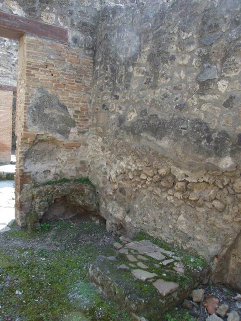 IX.1.27 Pompeii. March 2009. South-west corner at front of shop, with remains of hearth.
On the left of the entrance, were the hearth and an altar with a niche above it.
See BdI, 1867, (p.162).

According to Boyce, it was “a kind of altar with a small niche in the wall above it – presumably for the cult of the Lares”.
Apparently fixed to it there was a marble slab bearing the inscription -
PACVVIVS . ERASISTRATVS . EX . VIsv   [CIL X 930]
Boyce also noted that Fiorelli said nothing about the connection between the altar and the incised slab but noted that the slab had been re-used as materiale di costruzione.
See Boyce G. K., 1937. Corpus of the Lararia of Pompeii. Rome: MAAR 14. (p.80) 
See Pappalardo, U., 2001. La Descrizione di Pompei per Giuseppe Fiorelli (1875). Napoli: Massa Editore. (p.140)

Cooley translates the inscription to
Pacuvius Erasistratus, after a vision.    [CIL X 930]
See Cooley, A. and M.G.L., 2004. Pompeii: A Sourcebook. London: Routledge. (p.106, E58), where it is said to have come from IX.1.25.

According to Boyce above, the place of discovery of CIL X 930, was given as IX.1.25, but wrongly so; cf. Fiorelli and the Bull.Inst.
He gives the references - Fiorelli, Descr., 376; Bull. Inst., 1867, 162.


