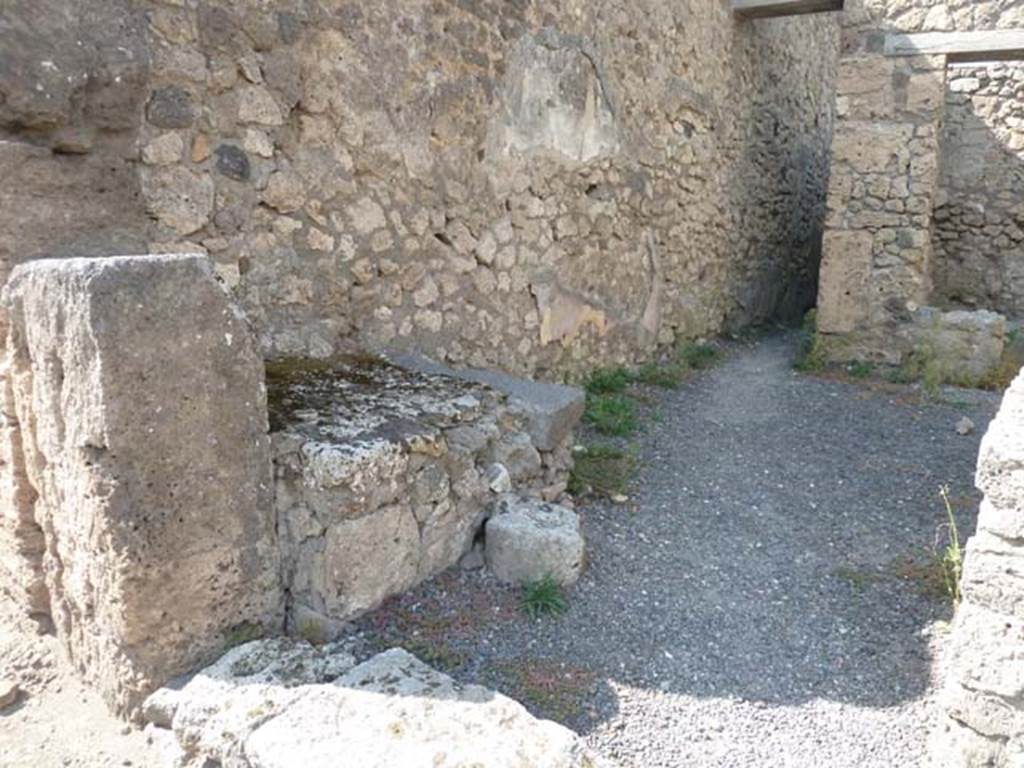 V.2.13 Pompeii. September 2015. West wall, with masonry hearth or base, and corridor to rear.