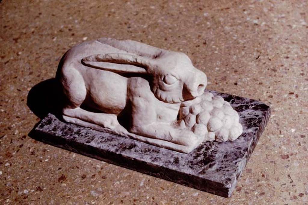 M.7. Pompeii. 1964. (Where from originally ?) Hare fountain statuette. The base is modern. Photo by Stanley A. Jashemski.
Source: The Wilhelmina and Stanley A. Jashemski archive in the University of Maryland Library, Special Collections (See collection page) and made available under the Creative Commons Attribution-Non Commercial License v.4. See Licence and use details.
J64f1774
Now in Naples Archaeological Museum. Inventory Sangiorgio Vol. 82 n. 742.
