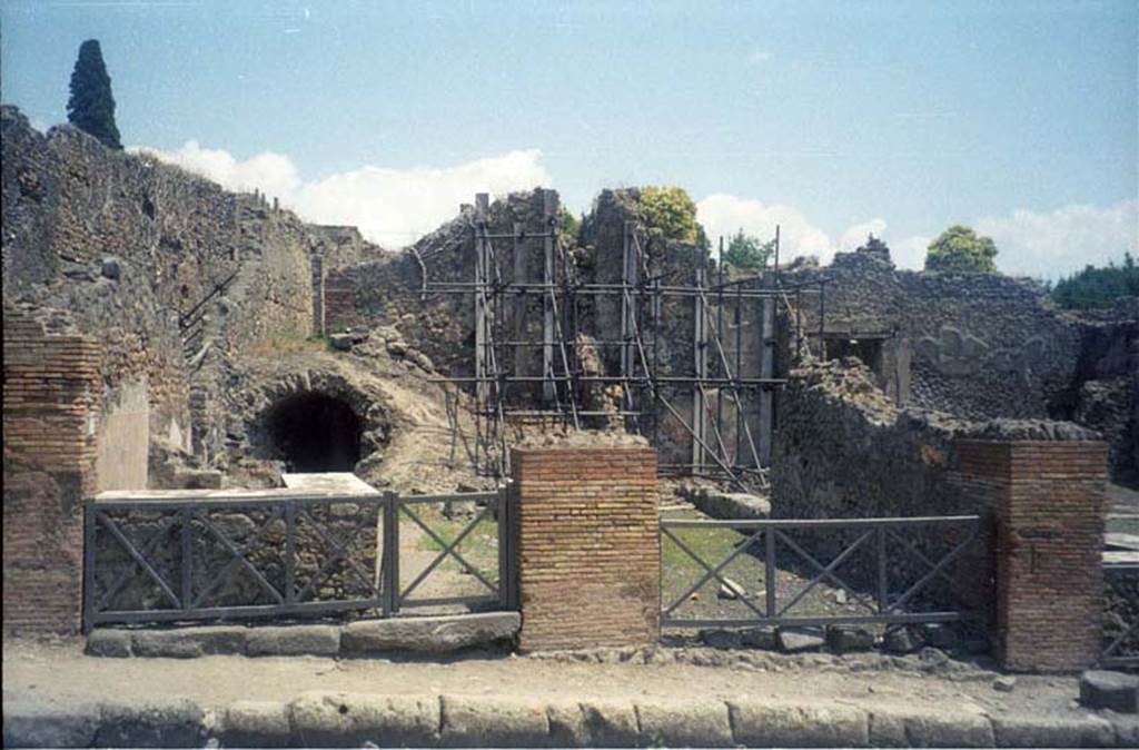 I.2.12 Pompeii. July 2011. Looking east to entrance doorway (on right) from Via Stabiana. Photo courtesy of Rick Bauer.
Warscher described this, quoting Fiorelli, as  I.2.12/13  due taberne aventi comunicazione tra loro.  Il podio  rivestito di marmi.  Qui linsula  delimitata dalla via secunda, sulla quale si aprono glingressi di altre abitazioni.
See Warscher T., 1935. Codex Topographicus Pompeianus: Regio I.2. Rome: DAIR.
(translation: "I. 2.12/13 - two workshops having communication between them.  The podium was covered with marble.   Here the insula is bounded by via secunda, on which opens the entrances of other dwellings.")
