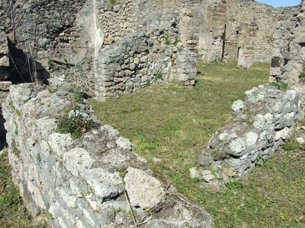 I.2.17 Pompeii. March 2009. Looking over wall in corridor, looking north-west through doorway in north wall of room 11. Looking north into room 12, the oecus that led through to room 13, the peristyle garden. Room 4 is shown in upper left-hand corner, on the north side of room 12.

