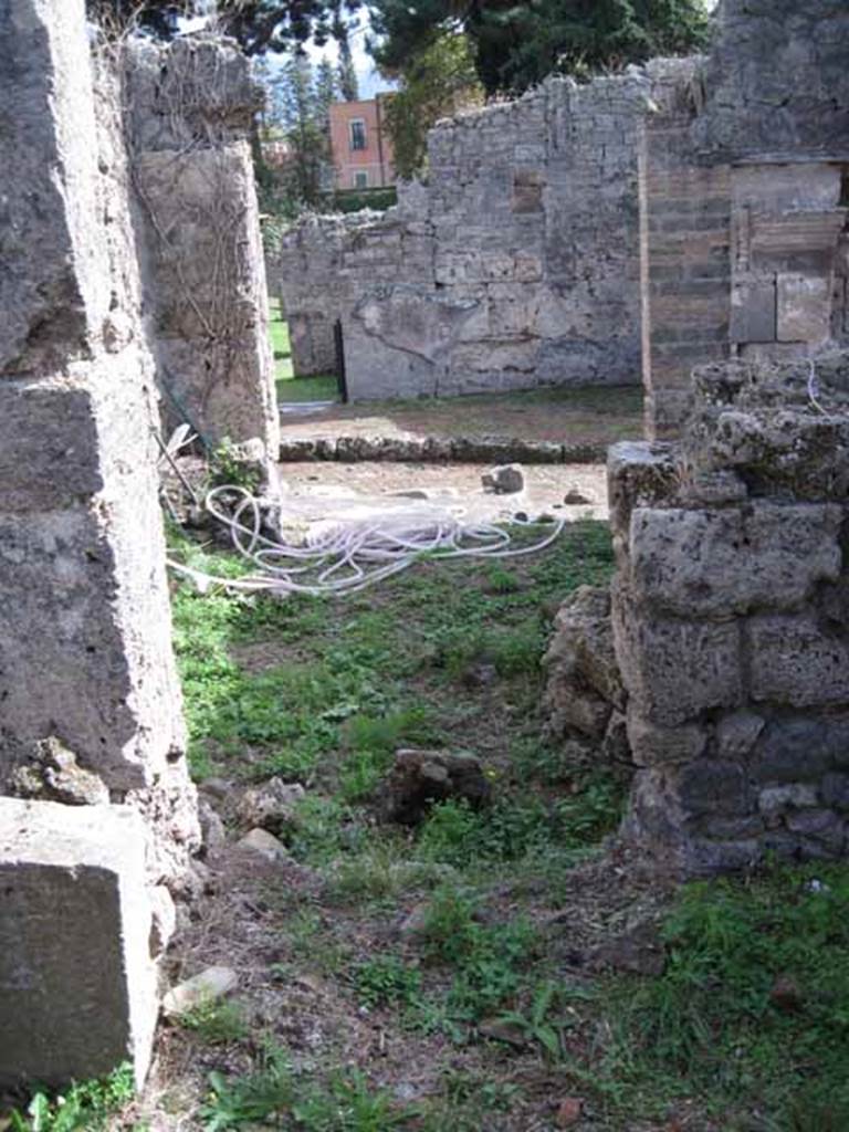 I.2.24 Pompeii. September 2010.  South side of room, looking south through I.2.25 onto Vicolo del Conciapelle . Photo courtesy of Drew Baker.
