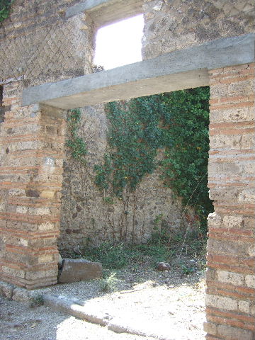 I.3.27 Pompeii.  March 2009. Remains of plaster on north wall of small room.