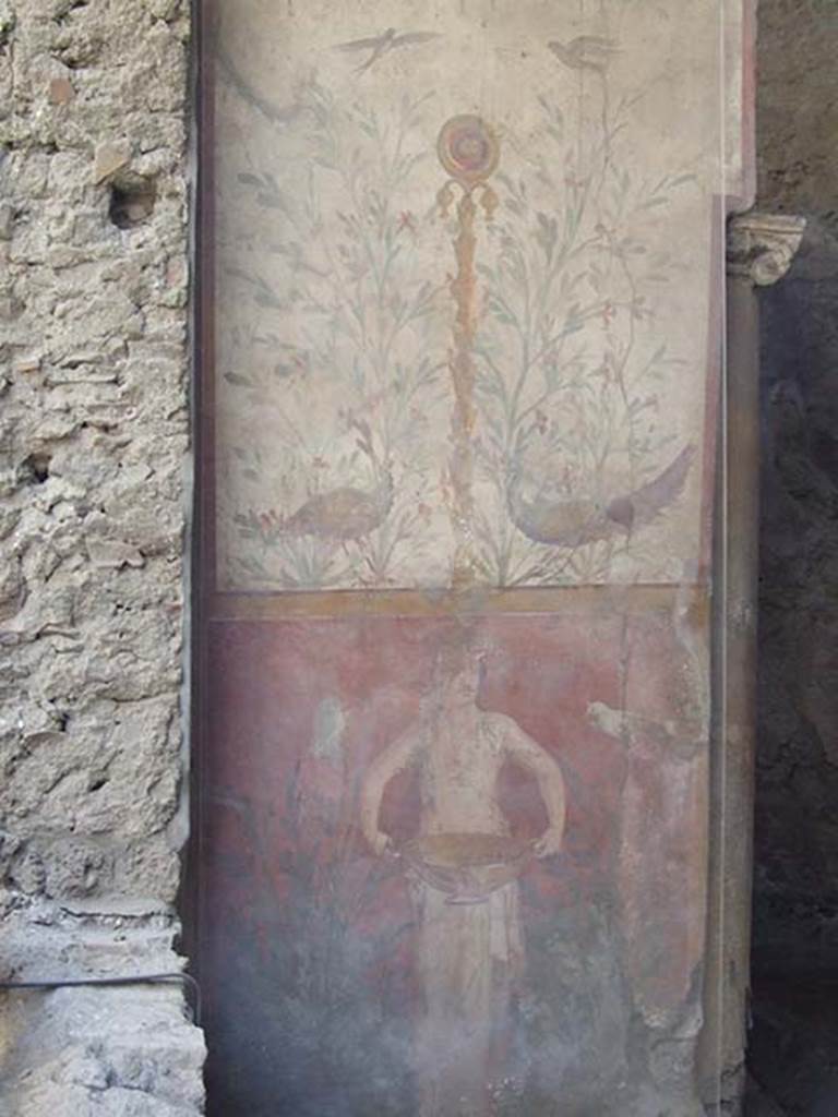 I.6.15 Pompeii. May 2009. Room 9, small garden. 
Wall on west side with painting with birds, plants and a medallion above a figure holding a basin or bowl.
