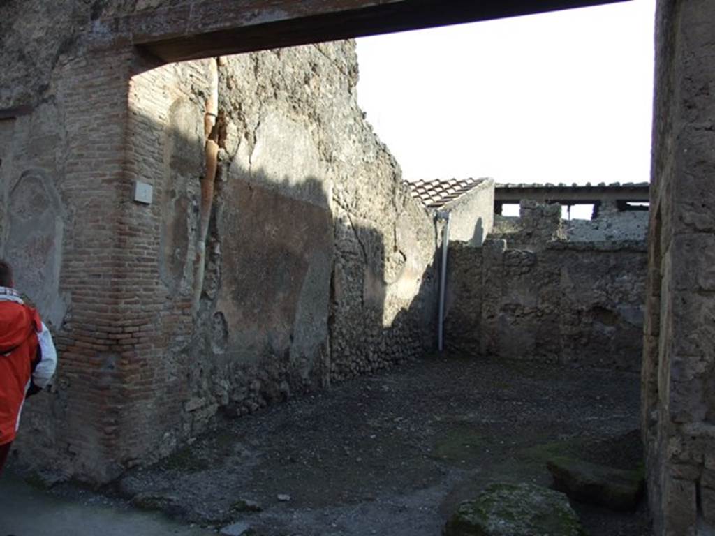 I.7.4 Pompeii. December 2007. Entrance, looking south.
According to Wallace-Hadrill, this was a taberna/officina vasaria of Corinthus, servus of P. Cornelius?.
This comprised of two rooms and stairs up to an upper floor, but no decoration was found.
Finds of pottery have suggested officina vasaria (a potters shop).
See Wallace-Hadrill, A., 1994. Houses and Society in Pompeii and Herculaneum. New Jersey: Princeton U.P. (p.189).
According to Spinazzola,
A "Corinthus" appears here, with pottery skills in terracotta, which may perhaps be attributed to a single "Figulus" (latin: potter/worker of earthenware) of exception: a large thick table/board with raised border (m. 1.18 side to side), was found mutilated in a house not yet explored on the side of Via di Abbondanza (II.2.4 or I.12.4), and a large vase with ornate decoration in relief, which more precisely identified him as a true artist, (from i.7.2/3).
In the great table he signed his skilful piece of pottery, accompanying his name with the pottery workshop "de fi(glinis) C(ai) Cluenti Ampliati  Corinthus fecit", of which he evidently was the master operator, and, in the vase, with the entire description, which more precisely identified him: 
"P. Corneli Corint(h)i servos"
See Spinazzola, V. Pompei, alla luce degli Scavi Nuovi di Via dellAbbondanza (Anni 1910-1923), Vol.2, (p.687, fig.651).
See Maiuri, A., 1928. Nuovi Scavi nella Via dellAbbondanza. Milano: Hoepli. (p.15-16).
See Notizie degli Scavi di Antichit, 1912, p. 65-7.
See Notizie degli Scavi di Antichit, 1927, (p. 12).
