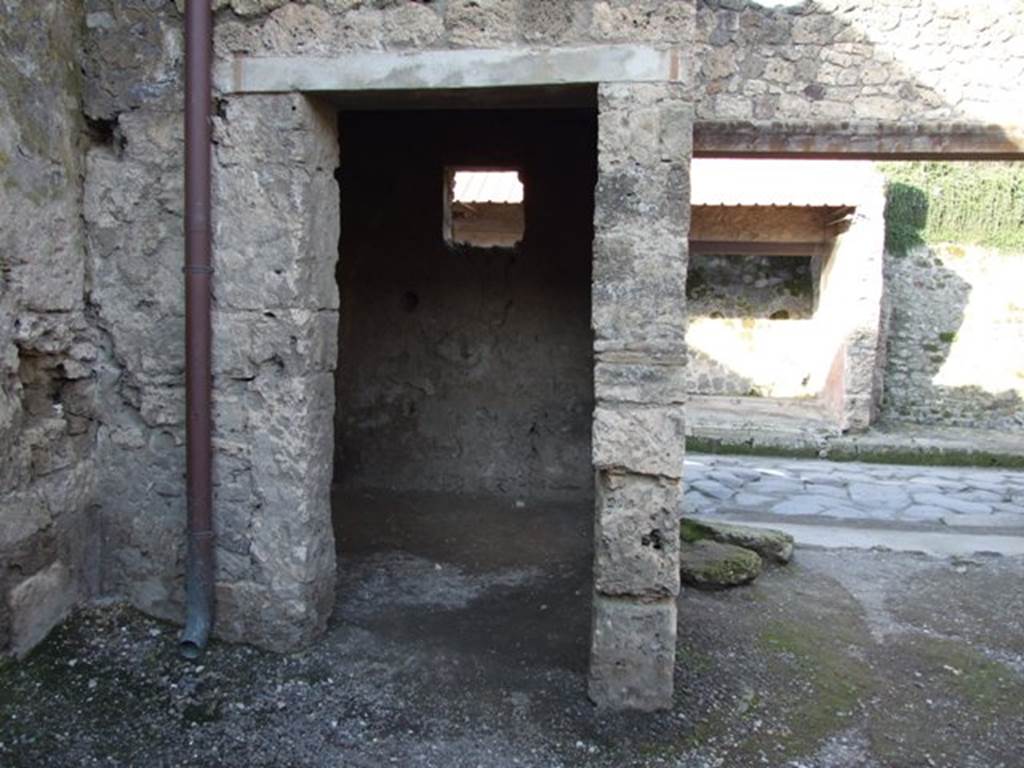 I.7.4 Pompeii. December 2007. Doorway to small room in north-west corner.
According to Eschebach, this small room had a hearth and tripod, together with a small window onto the street. There was also a larger window onto the entrance area. See Eschebach, L., 1993. Gebudeverzeichnis und Stadtplan der antiken Stadt Pompeji. Kln: Bhlau. (p.38)

