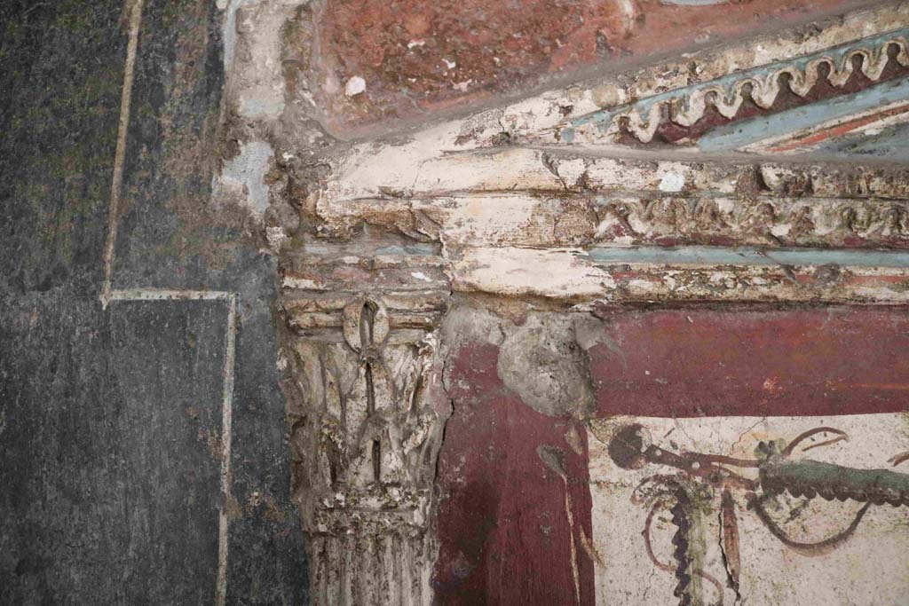 I.8.8 Pompeii. December 2018. Detail of stucco decoration on south wall, with east side of pediment above lararium. Photo courtesy of Aude Durand.
