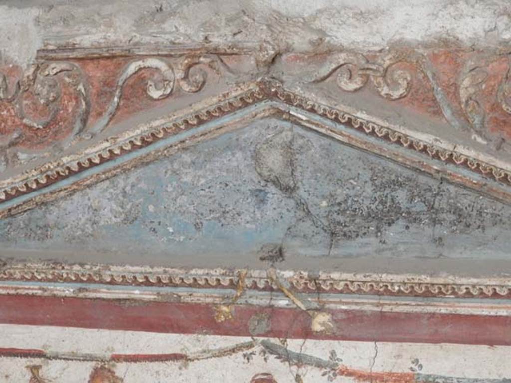 I.8.8 Pompeii. May 2015. Detail of centre of pediment on south wall above lararium.
Photo courtesy of Buzz Ferebee.
