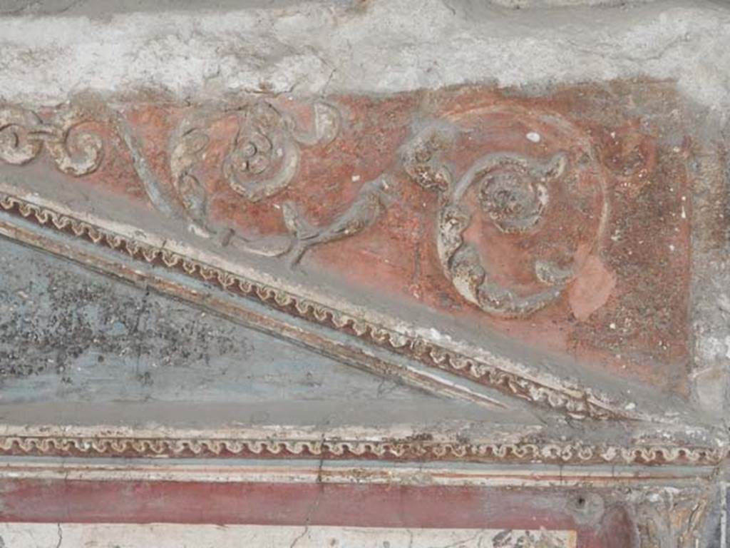 I.8.8 Pompeii. May 2015. Detail of stucco decoration on south wall, with west side of pediment above lararium. Photo courtesy of Buzz Ferebee.
