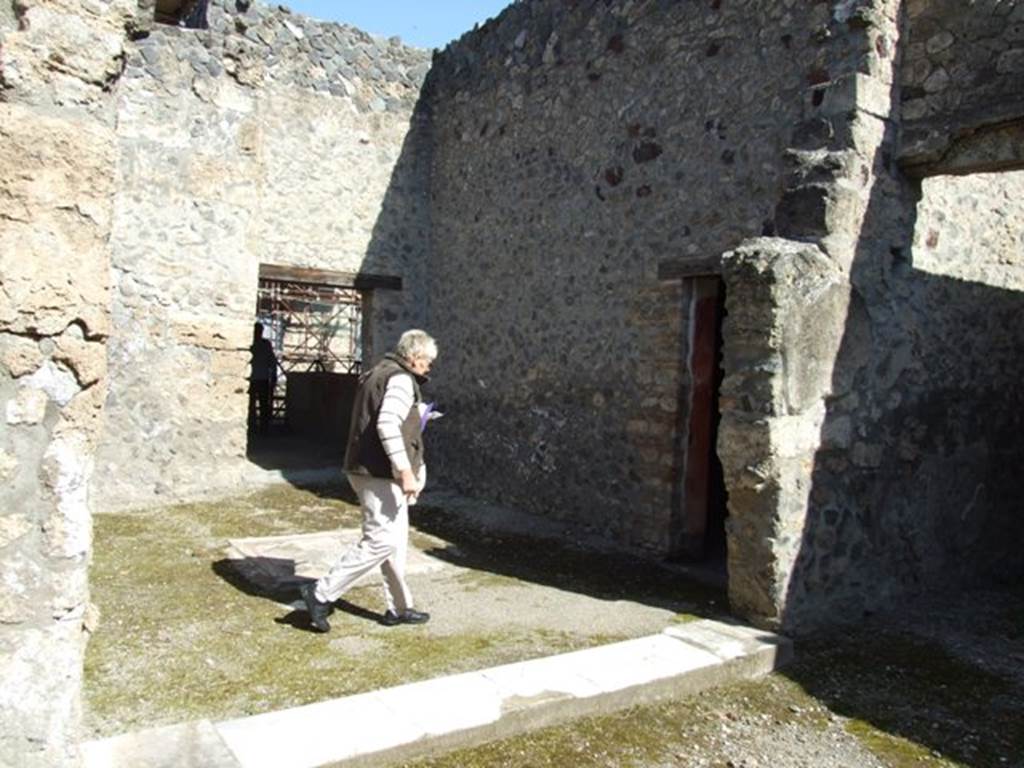 I.8.9 Pompeii. March 2009. Room 2, oecus. Looking north to caupona, with the doorway to rear room, a triclinium, of caupona, on right of photo. 
