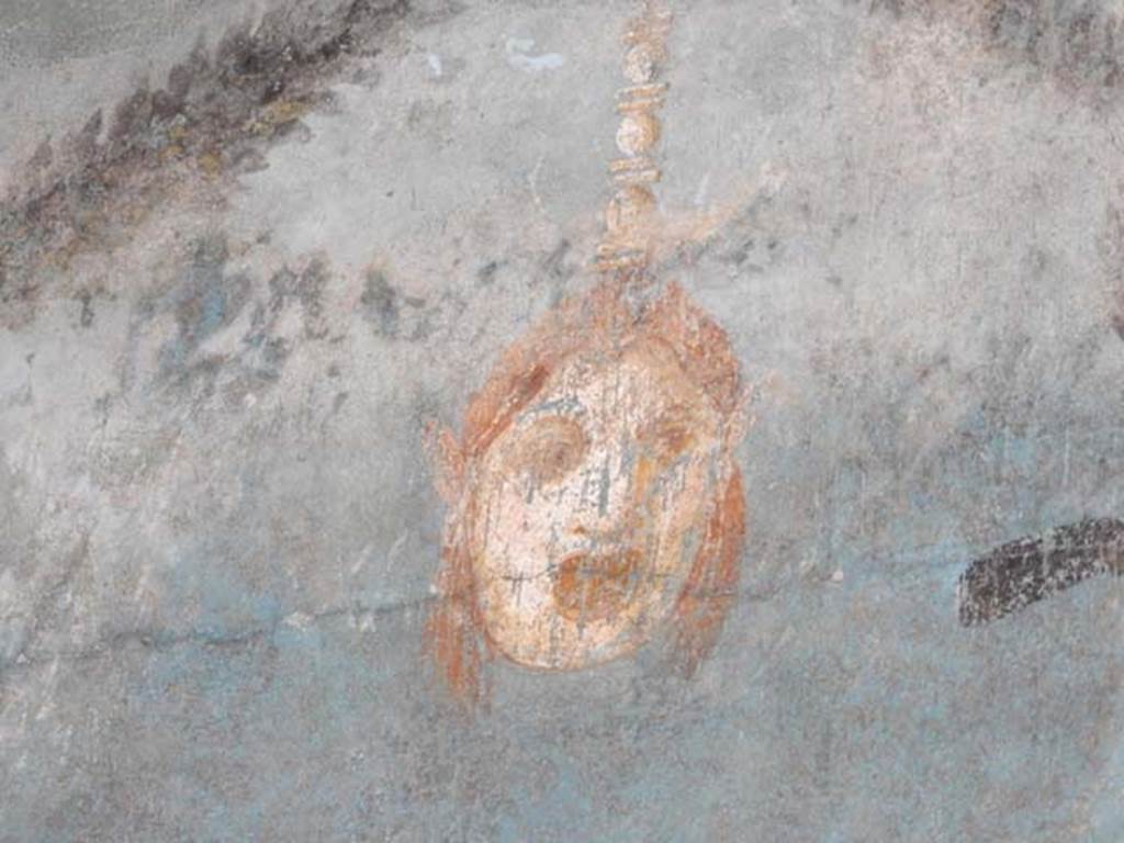 I.9.5 Pompeii, May 2018. Room 5, painted mask from centre of upper east wall. Photo courtesy of Buzz Ferebee.

