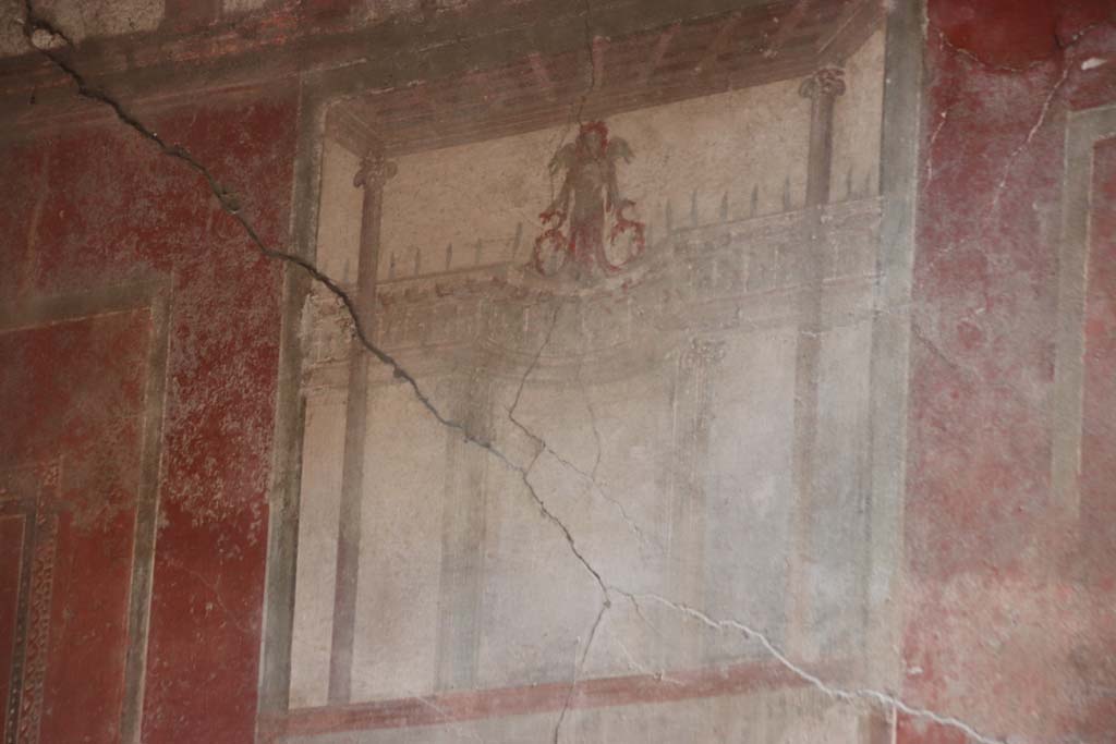I.10.4 Pompeii. September 2021. Room 4, detail from above the central wall painting on south wall. Photo courtesy of Klaus Heese.