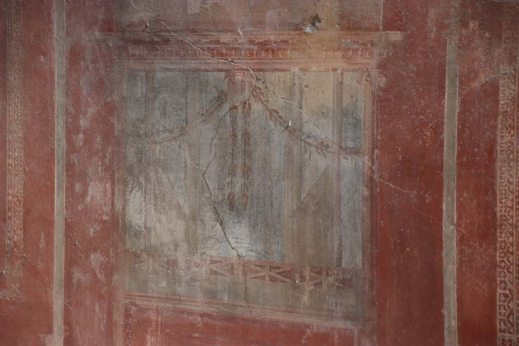 I.10.4 Pompeii. September 2021. 
Room 4, detail of painted decoration from south wall below the centre painting. Photo courtesy of Klaus Heese.
