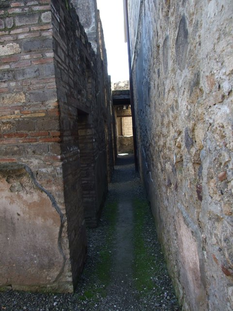 I.10.15 Pompeii.  March 2009.  Remains of columns in floor of corridor between peristyle and servants quarters.
