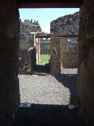 I.11.12 Pompeii. September 2005.  Corridor to garden, and doorway to room.