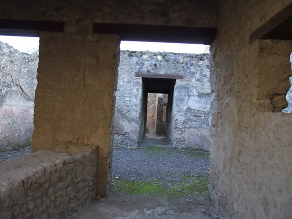 I.12.5 Pompeii. December 2007. Looking south across atrium to corridor leading to garden.
According to Wallace-Hadrill, this property comprised a shop area with counter.
At the rear was a displuviate atrium, and three other rooms.
In the backyard were well constructed masonry stairs to the upper floor, and a large lined basin surrounded by low wall. 
When he conducted his survey, there were faded style III and IV style decoration in three rooms.
See Wallace-Hadrill, A, (1994): Houses and Society in Pompeii and Herculaneum, UK, Princeton Univ. Press, (p.196)
