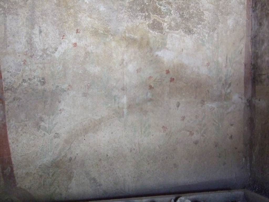 I.12.8 Pompeii.  March 2009.  Room 10.  West wall.  Remains of Lararium, painted with plants and birds. The legs of the Lares used to be visible at the top of the wall, but only their booted legs, the upper parts were destroyed. 
See Giacobello, F., 2008. Larari Pompeiani: Iconografia e culto dei Lari in ambito domestico.  Milano: LED Edizioni.  (p.152-3).