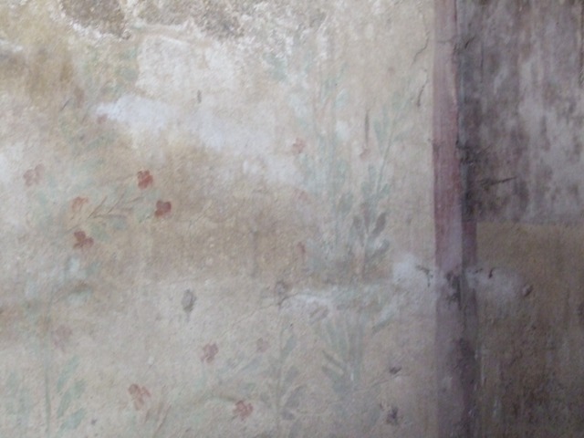 I.12.8 Pompeii.  March 2009.  Room 10.  West wall.  Remains of Lararium, painted with plants and birds. The legs of the Lares used to be visible at the top of the wall, but only their booted legs, the upper parts were destroyed. 
See Giacobello, F., 2008. Larari Pompeiani: Iconografia e culto dei Lari in ambito domestico.  Milano: LED Edizioni.  (p.152-3).