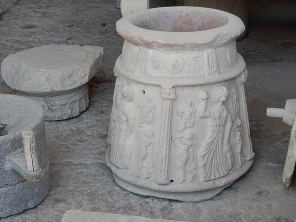 I.13.8 Pompeii? May 2018. Terracotta puteal with moulded decoration of columns and Bacchic figures in storage in VII.7.29.
According to Roberts,
there are three scenes divided by columns each showing a Maenad with tambourine and castanets with seated figures, perhaps Bacchus, and satyrs playing the twin pipes (auloi).
See Roberts, P., 2013. Life and Death in Pompeii and Herculaneum. London: British Museum Press, p. 153, fig. 167.
PAP inventory number 44908.
Photo courtesy of Buzz Ferebee.

