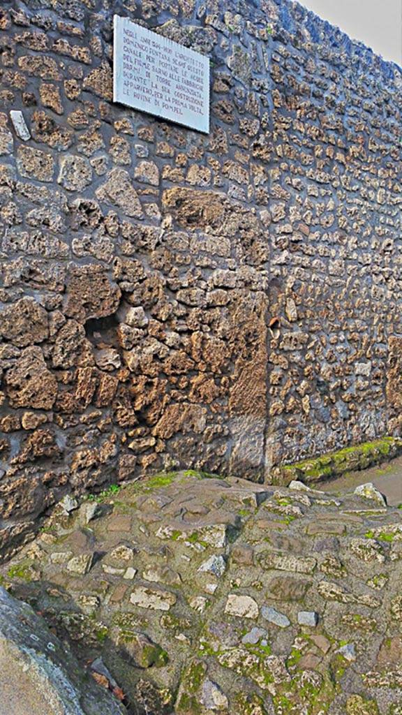 Between I.14.4 and I.14.5 in Via di Nocera, Pompeii. 2017/2018/2019.
Route of Sarno Canal below roadway, and descriptive plaque. 
Photo courtesy of Giuseppe Ciaramella.

