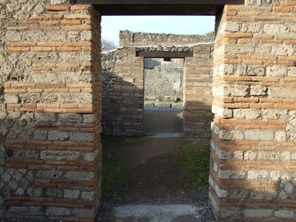 II.1.4 Pompeii.   December 2007.  Looking north across middle room to entrance room on Via dell Abbondanza.

