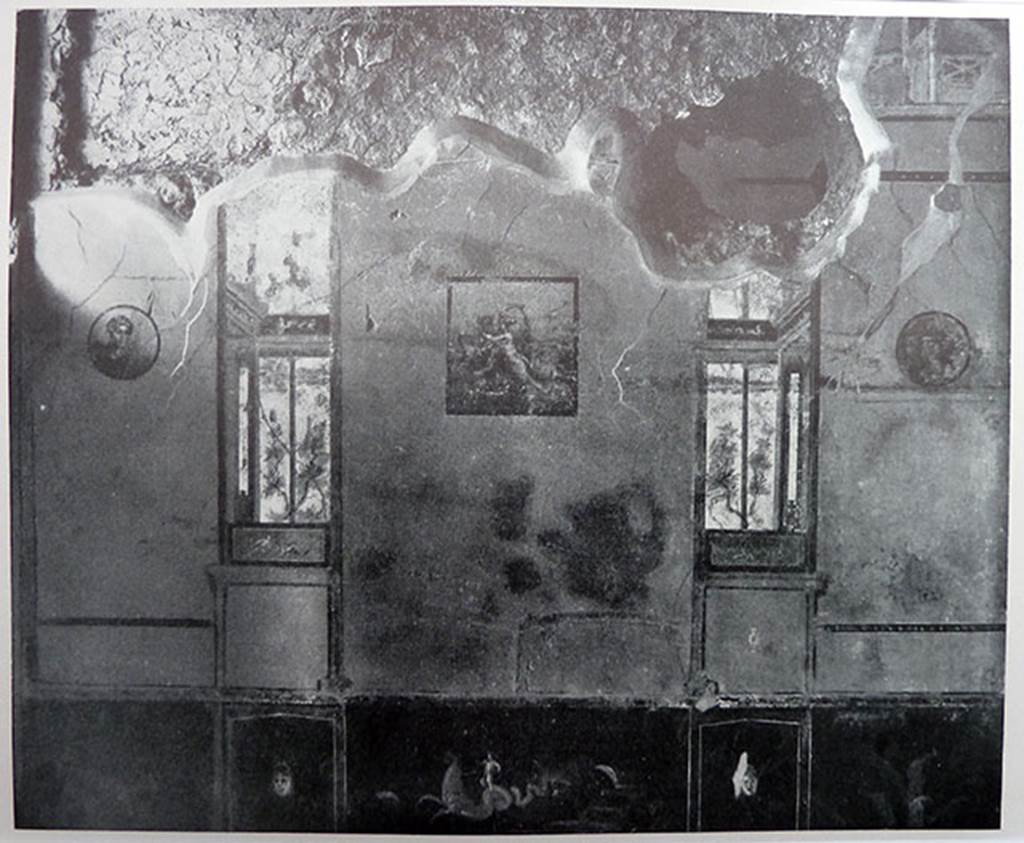 II.2.2 Pompeii. Old photograph of south wall of room “a” cubiculum.
The south wall showed a central painting of Europa and the Bull, with two medallions and imitation painted windows, prior to the 1943 bombing.
The zoccolo/dado was painted black and the middle zone of the walls would have been yellow.
