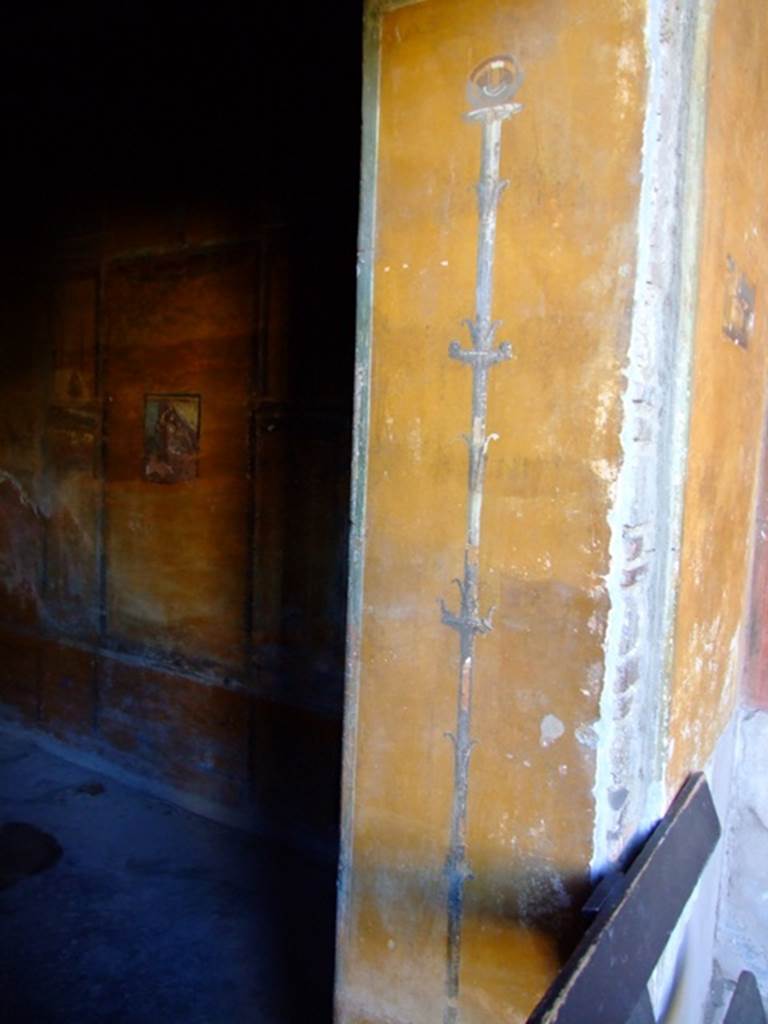II.3.3 Pompeii. March 2009. Doorway to room 12, painted candelabrum on north side.