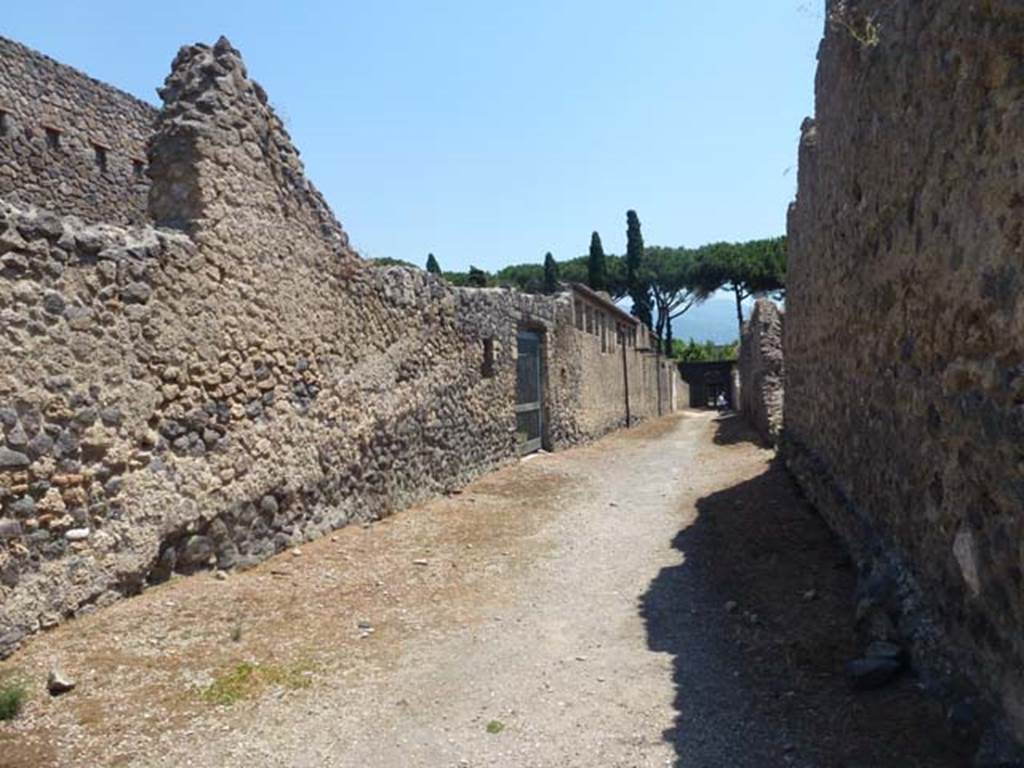 II.4.1 Pompeii, on left. June 2012. Roadway looking south towards doorway to II.4.12 (centre), with II.3.4, on right. Photo courtesy of Michael Binns.
