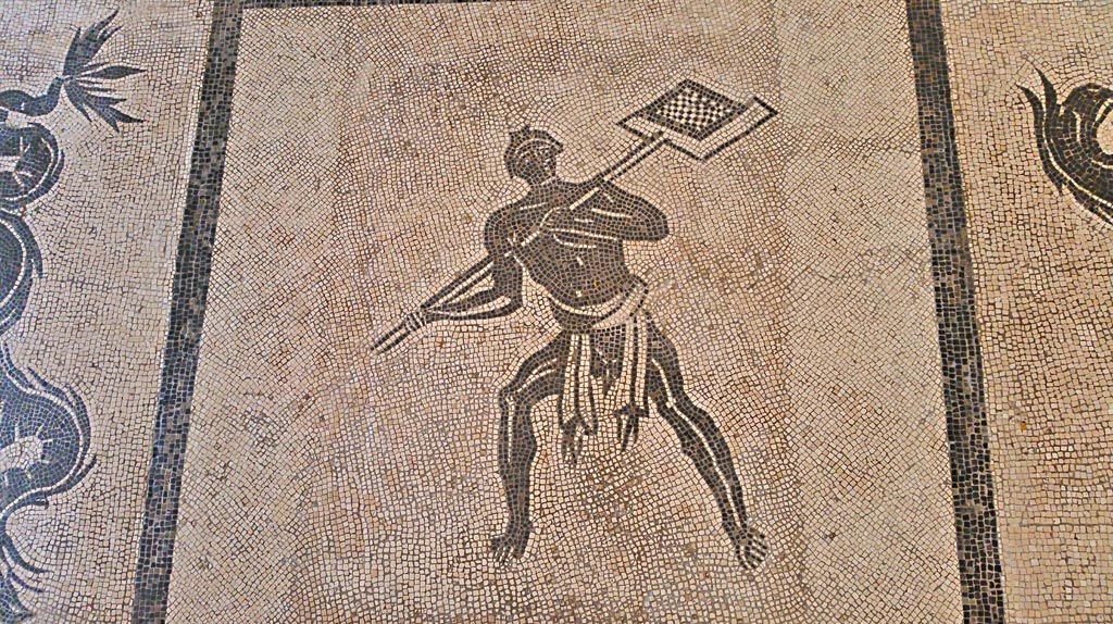 II.4.6 Pompeii. July 2019.  
Black and white mosaic from centre of floor showing a furnaceman and a marine scene set in floor of Naples Museum.
Photo courtesy of Giuseppe Ciaramella.

