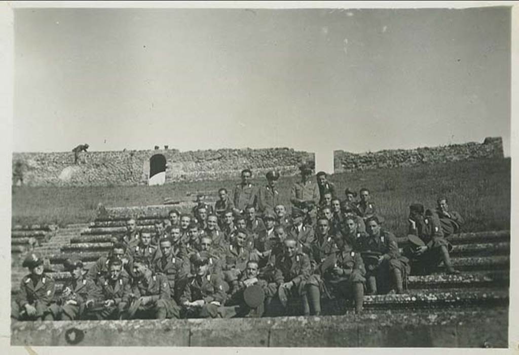 II.6 Pompeii. 26th October 1936. Italian soldiers sitting as a group in the amphitheatre.
Photo courtesy of Rick Bauer.

