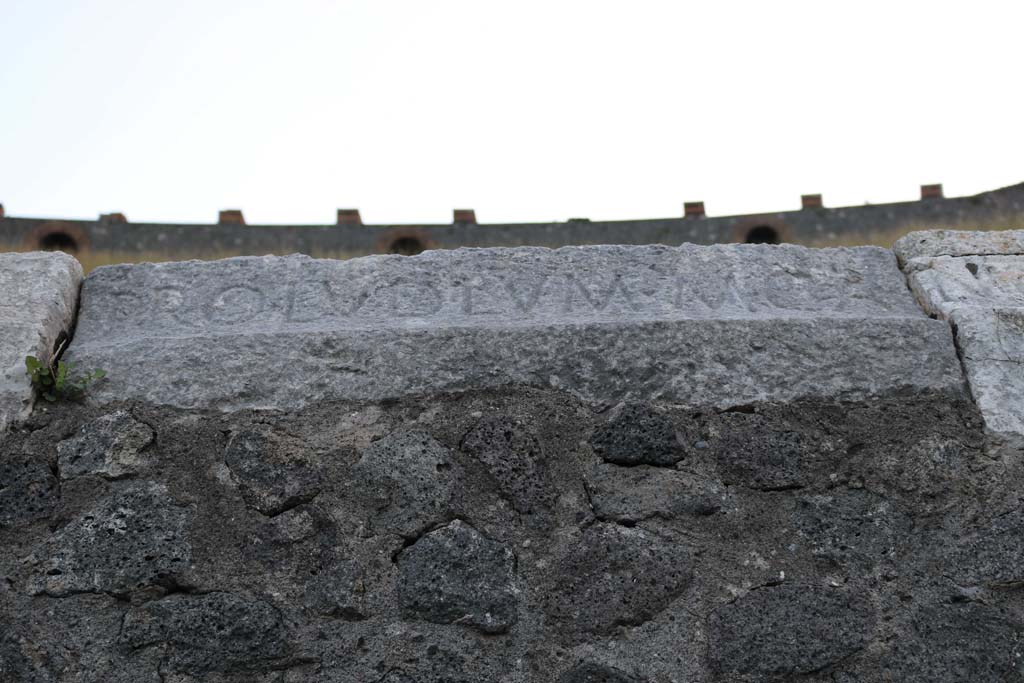 II.6 Pompeii. December 2018. Inscription carved on rim of inner wall of the arena of the amphitheatre. Photo courtesy of Aude Durand.