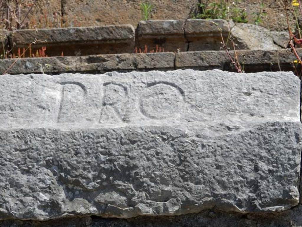 II.6 Pompeii. May 2016. Inscription carved on rim of inner wall of the arena of the Amphitheatre.
Inscription PRO, part of CIL X 854. Photo courtesy of Buzz Ferebee.
