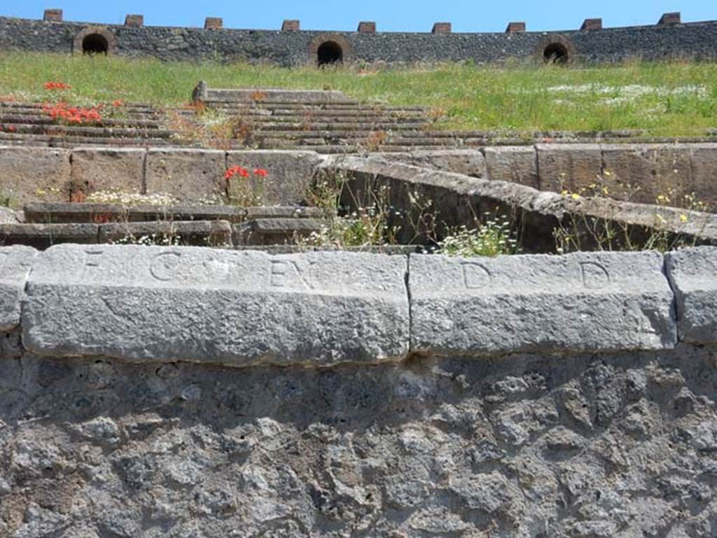 II.6 Pompeii. May 2016. Inscription carved on rim of inner wall of the arena of the Amphitheatre.
Inscription F. C. EX. D. D., part of CIL X 854. Photo courtesy of Buzz Ferebee.

