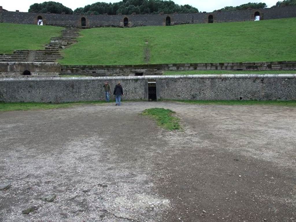 II.6 Pompeii. December 2006. Arena and seating, west side. Showing doorway to tunnel leading from arena floor to outside the Amphitheatre.
