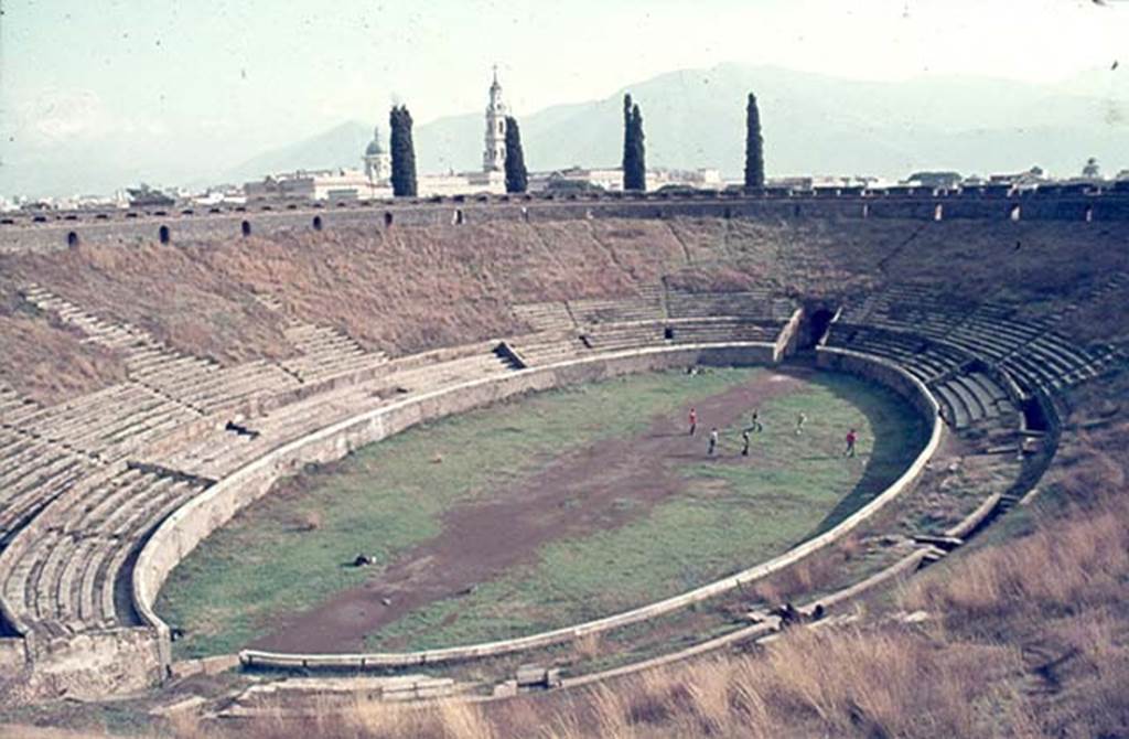 II.6 Pompeii. January 1977. Looking south-east across Amphitheatre, from upper level.
Photo courtesy of David Hingston.

