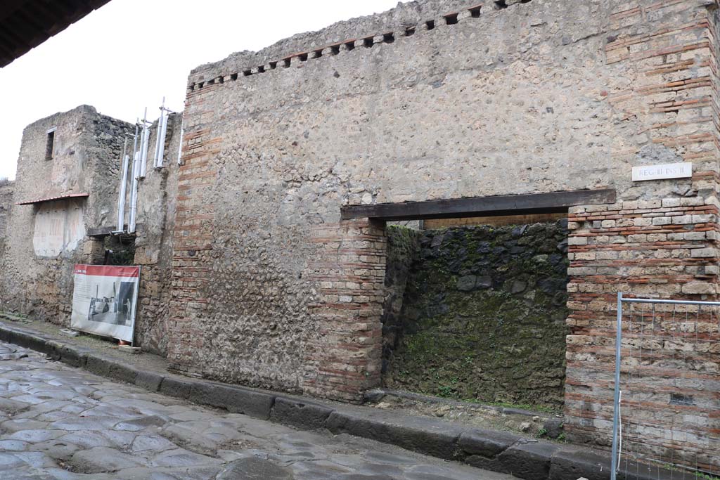 III.2.3 Pompeii, on right, and III.2.2, on left. December 2018. 
Entrance doorways on north side of Via dellAbbondanza. Photo courtesy of Aude Durand.

