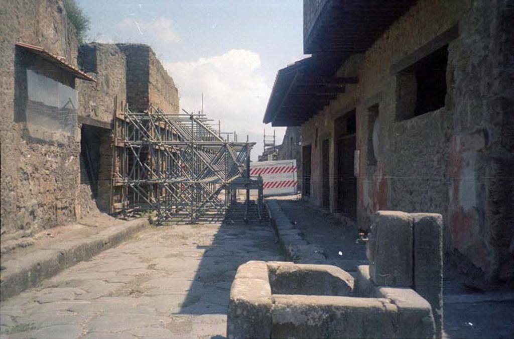 III.2.3 Pompeii. July 2011. Looking east on Via dellAbbondanza, showing scaffolding outside entrance. Photo courtesy of Rick Bauer.