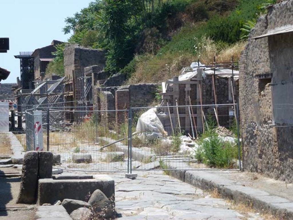 III.3.6 (centre) and III.4.1(on right) Pompeii. June 2012. Looking west along north side of Via dellAbbondanza. Photo courtesy of Michael Binns. 
