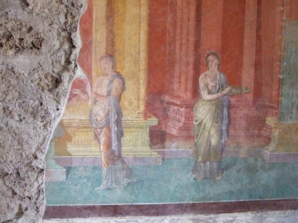 III.4.b Pompeii. March 2009. Room 3, west wall of oecus. Two figures, one carrying a plate.