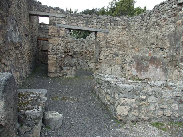 V.2.13 Pompeii,  March 2009. North wall, with corridor to kitchen and latrine and doorway to rear room.