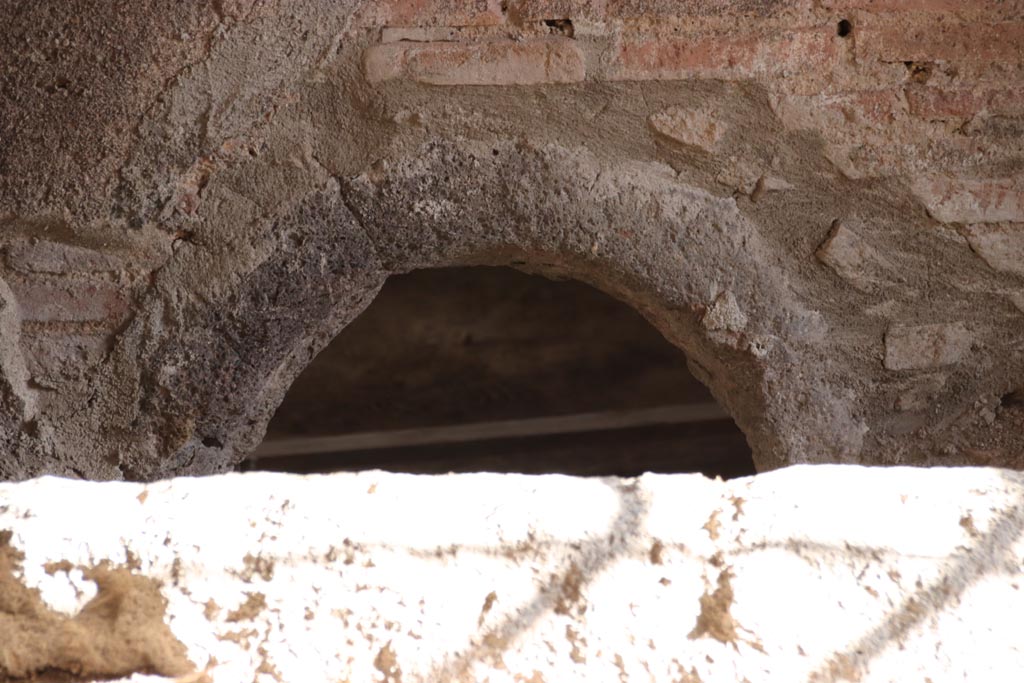 V.2.i Pompeii.  October 2023. 
Kitchen room 11, wall at south end near the caldarium showing a hole in the floor, used to heat the bath-rooms. Photo courtesy of Klaus Heese.
