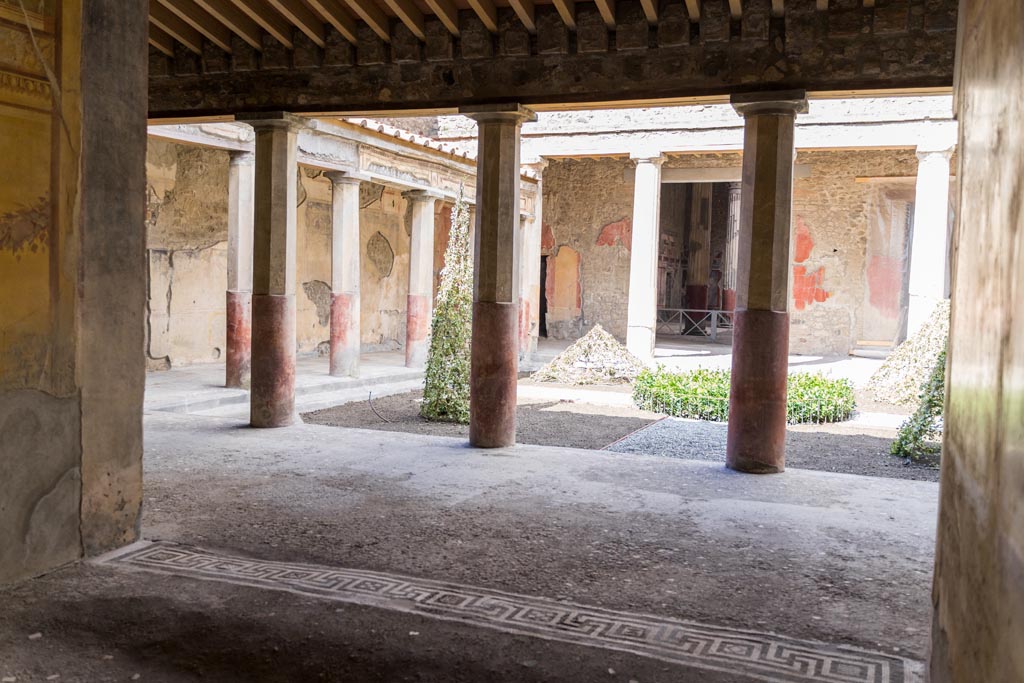 V.2.i Pompeii. March 2023. Room 19, looking north across mosaic threshold of exedra to peristyle. Photo courtesy of Johannes Eber.