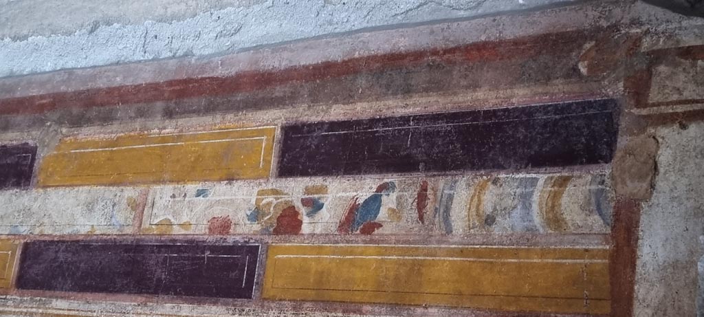 V.2.i Pompeii. December 2023. Room 20, detail of painted decoration from upper west wall at north end. Photo courtesy of Miriam Colomer.