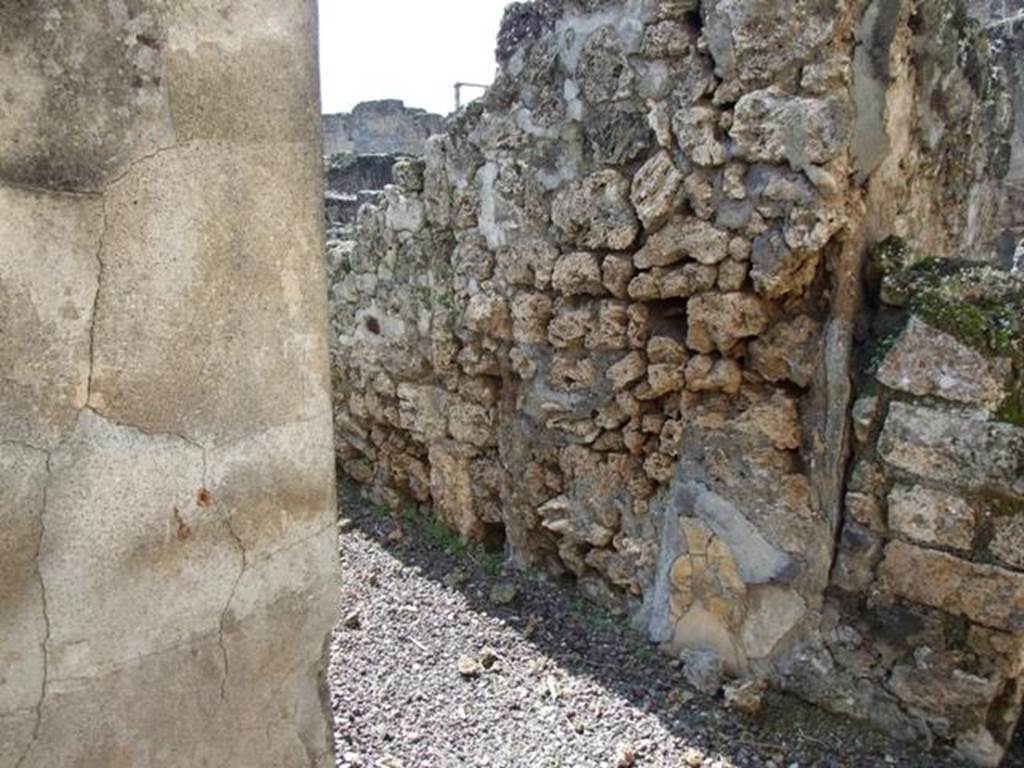 V.4.3 Pompeii.  March 2009.  Doorway to cupboard in south wall of Triclinium.