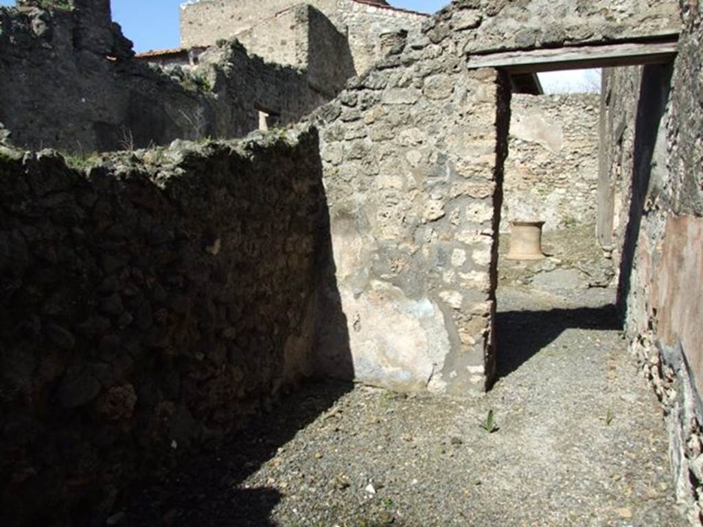 V.4.3 Pompeii. March 2009. Site of staircase to upper floor, on west side of corridor to rear. Looking north to doorway at end of corridor towards south portico and garden area.

