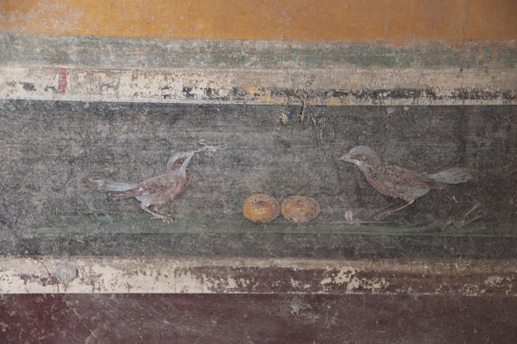 V.4.a Pompeii. October 2023.  
Room ‘g’, detail of bird painting in predella on lower east wall, on south side of central panel. Photo courtesy of Klaus Heese.
